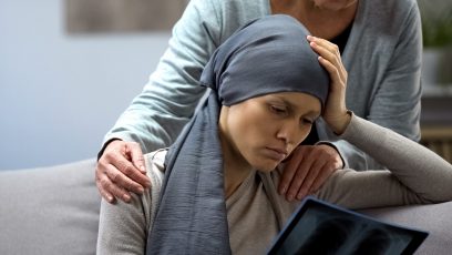 Woman with cancer looking at x-ray